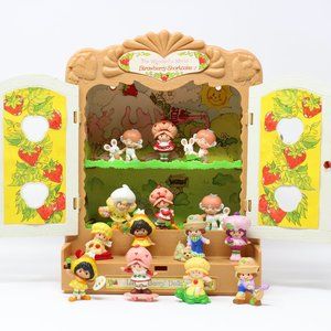 Vintage lot of 14 1980's Strawberry Shortcake PVC Figures and Display Case.